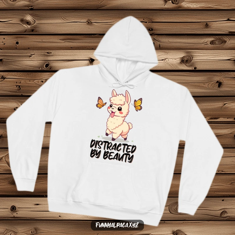 Funny hoodie with a playful alpaca, tongue sticking out, comically chasing a butterfly, radiating carefree energy and lightheartedness.